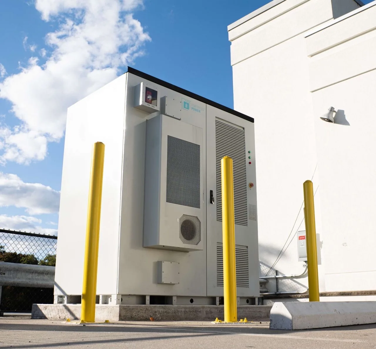 Battery energy storage cabinet installed outdoors at a commercial property