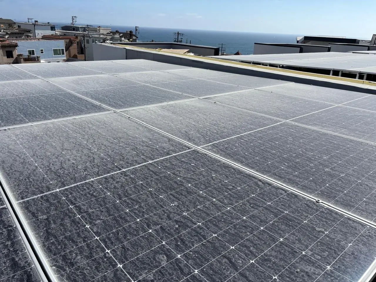 Rooftop solar array on a commercial building overlooking the coast