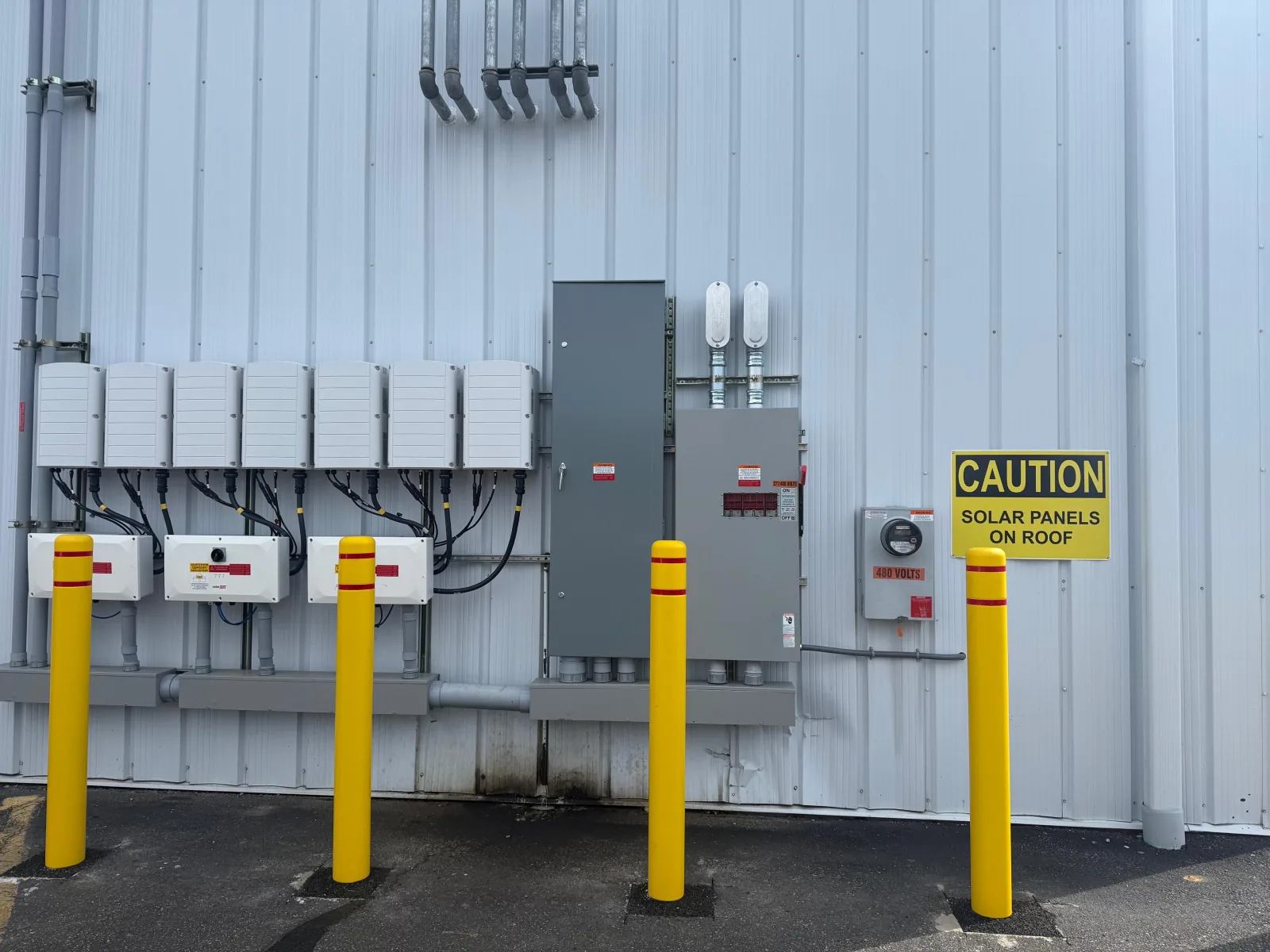 Inverter bank, switchgear and service equipment on a commercial building exterior